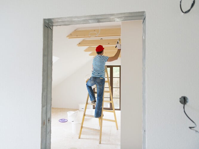 Man painting wall in new house