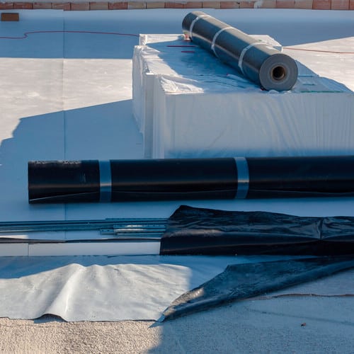 rolls of TPO roofing membrane on a roof
