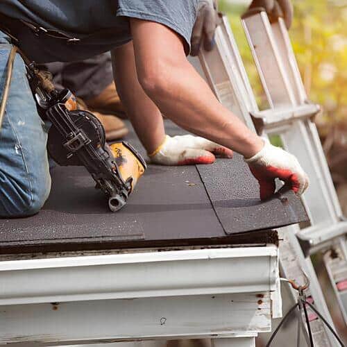 worker repairing a roof