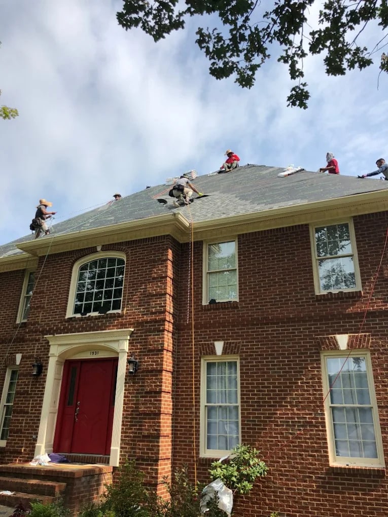 workers on the roof of a house