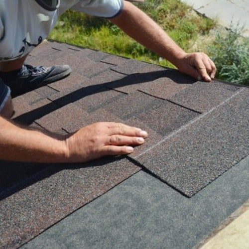 roofer repairing a leaking roof